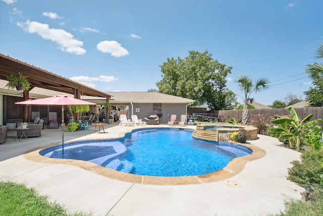 view of pool featuring a patio and an in ground hot tub