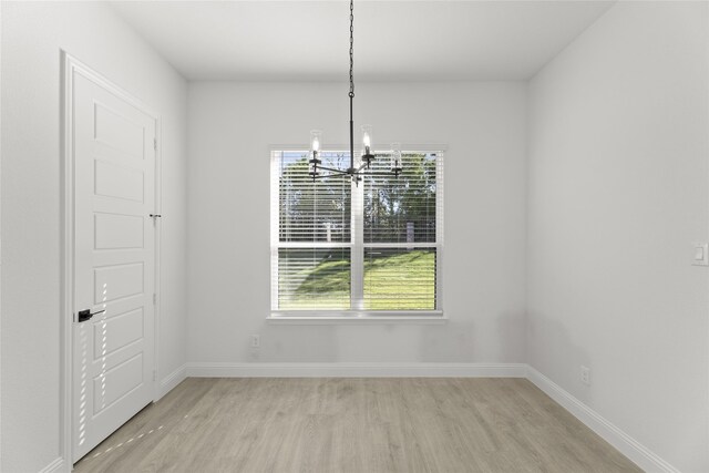 spare room featuring light hardwood / wood-style flooring and ceiling fan