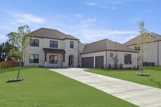 french country inspired facade featuring a front lawn and central AC unit