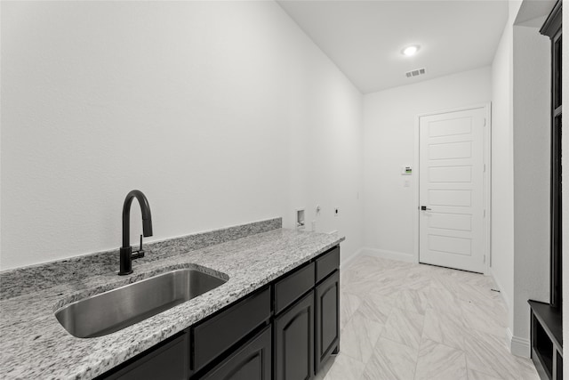 kitchen with sink and light stone counters