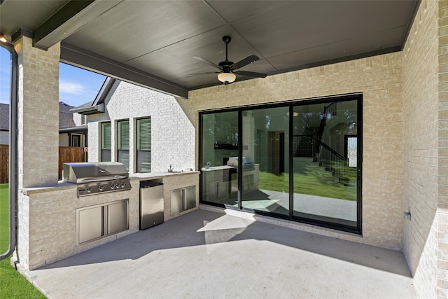 view of patio / terrace featuring exterior kitchen, area for grilling, sink, and ceiling fan