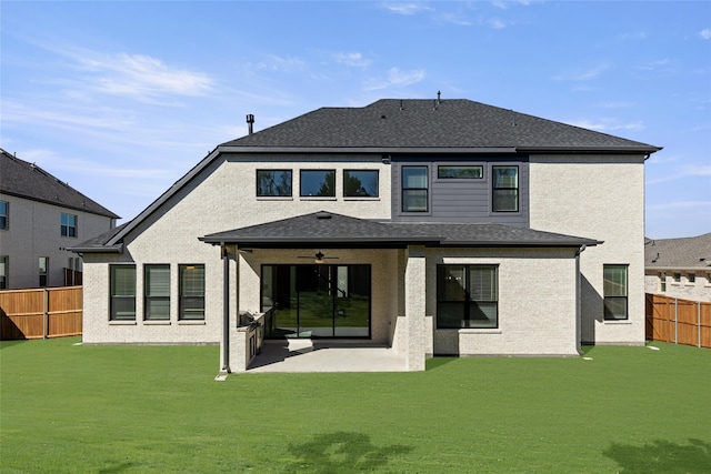 back of property featuring a yard and a patio