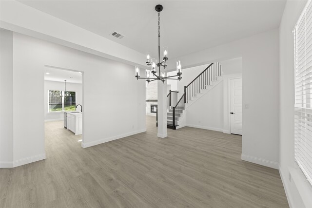 empty room with french doors, light hardwood / wood-style floors, and ceiling fan