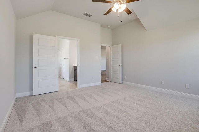 unfurnished bedroom with vaulted ceiling, light colored carpet, and ceiling fan