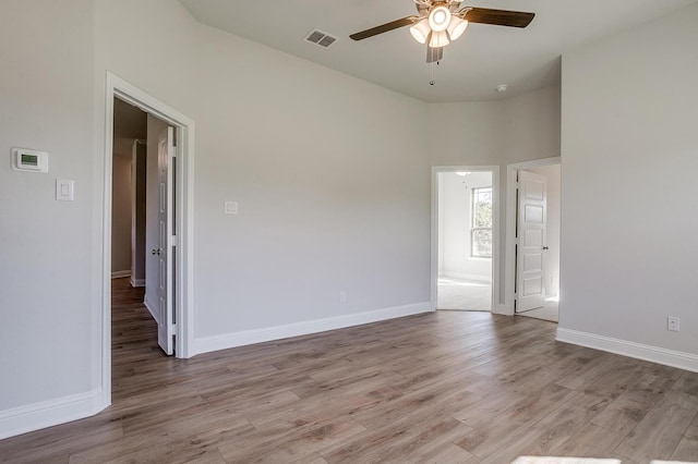 empty room with light wood-type flooring and ceiling fan