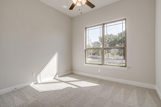 carpeted spare room with ceiling fan