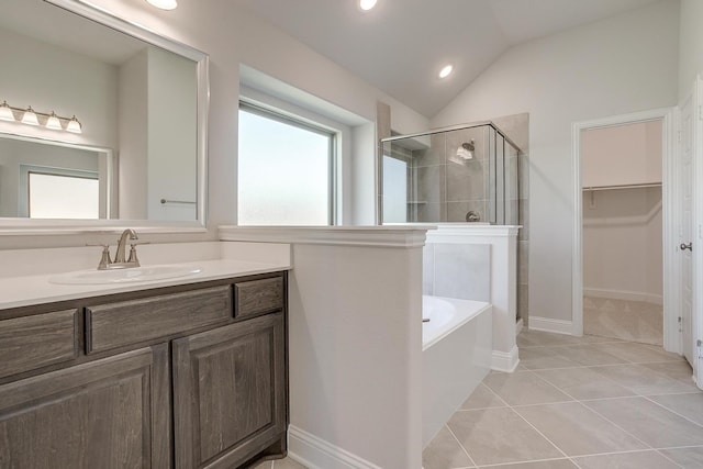 bathroom featuring tile patterned flooring, vanity, vaulted ceiling, and shower with separate bathtub