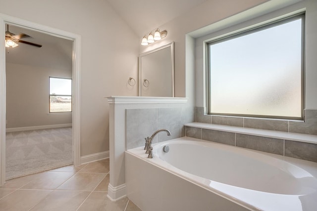 bathroom featuring tile patterned floors, ceiling fan, a bathtub, and vaulted ceiling