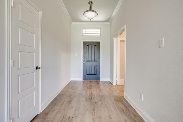 foyer featuring ornamental molding and light wood-type flooring