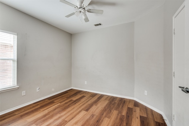 unfurnished room with wood-type flooring, a wealth of natural light, and ceiling fan