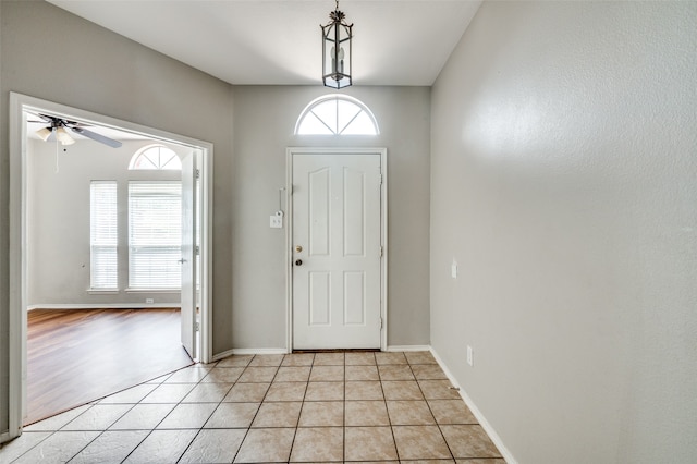 entryway featuring a healthy amount of sunlight, light tile patterned floors, and ceiling fan