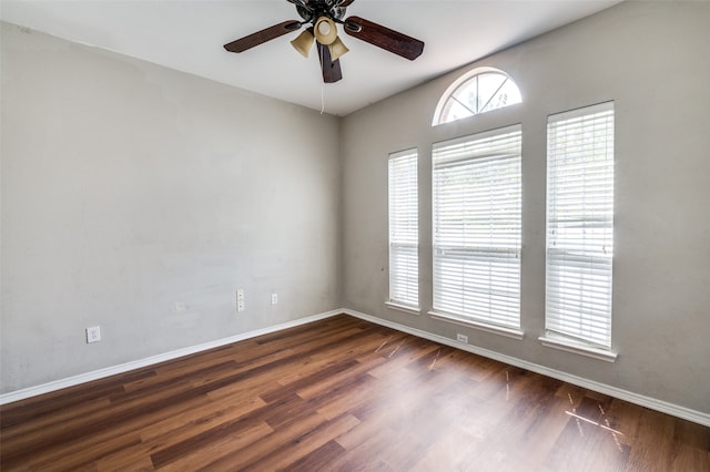 unfurnished room featuring dark wood-type flooring and ceiling fan