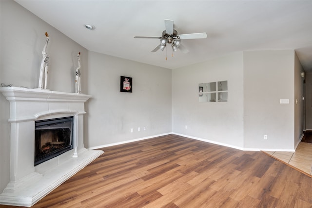 unfurnished living room with ceiling fan and hardwood / wood-style flooring