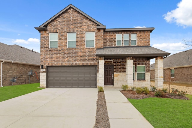 traditional-style home featuring a front yard, driveway, a shingled roof, a garage, and brick siding