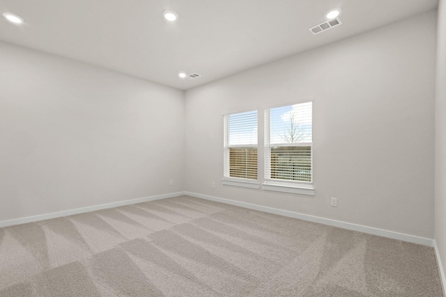 unfurnished room with light carpet