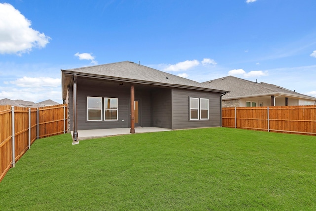 back of property with a patio area and a lawn