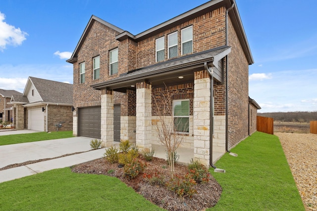 view of front of home with driveway, an attached garage, a front lawn, stone siding, and brick siding