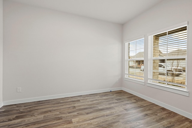 empty room featuring dark hardwood / wood-style flooring