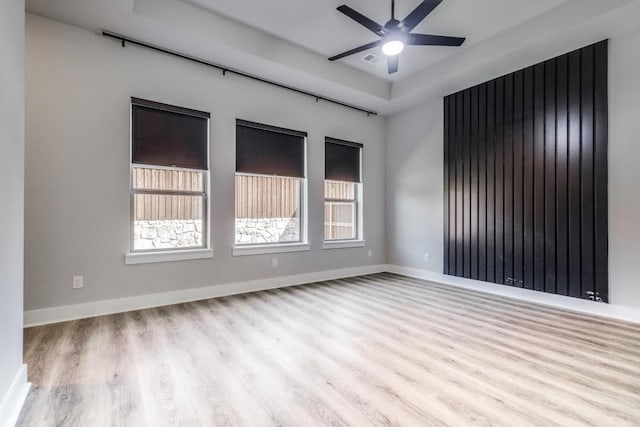 empty room with light hardwood / wood-style flooring and ceiling fan