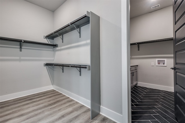 spacious closet featuring light hardwood / wood-style floors