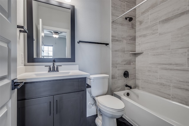 full bathroom featuring toilet, tiled shower / bath combo, vanity, and ceiling fan