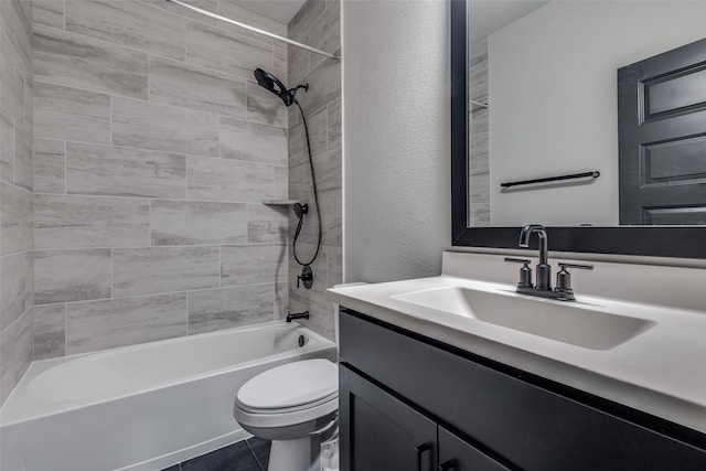 full bathroom featuring toilet, tiled shower / bath, vanity, and tile patterned floors