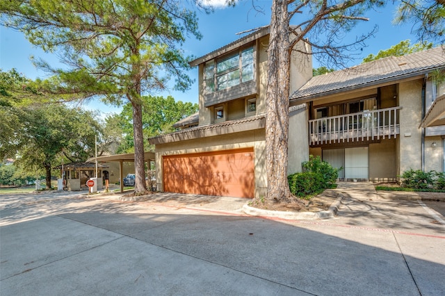 view of front of home featuring a balcony and a garage