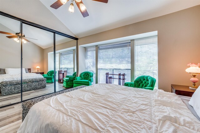 bedroom with hardwood / wood-style floors, a closet, ceiling fan, and multiple windows