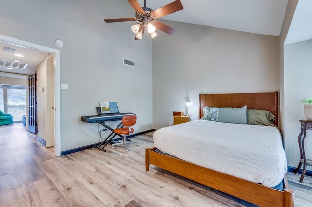 bedroom with ceiling fan, lofted ceiling, and light hardwood / wood-style floors