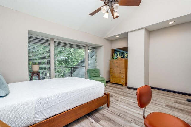 bedroom with ceiling fan, vaulted ceiling, and light wood-type flooring