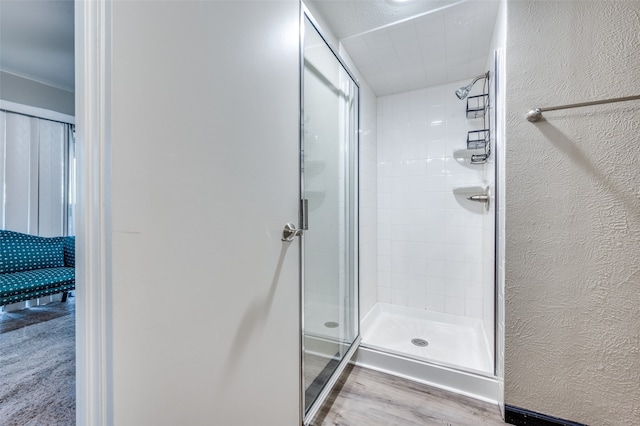 bathroom with walk in shower and hardwood / wood-style flooring