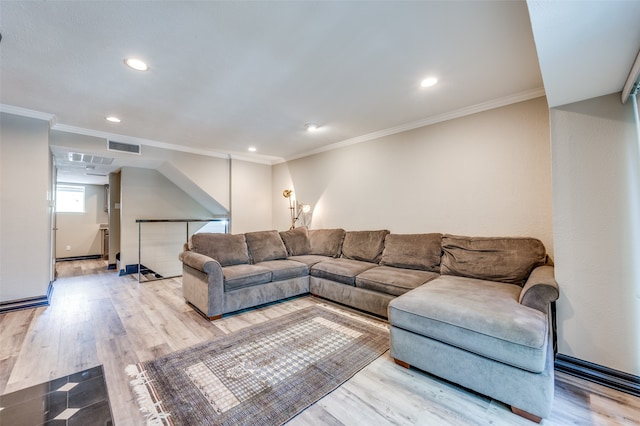 living room with light wood-type flooring and crown molding