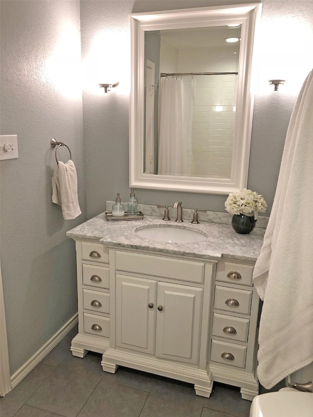 bathroom with tile patterned floors, vanity, toilet, and a shower with curtain