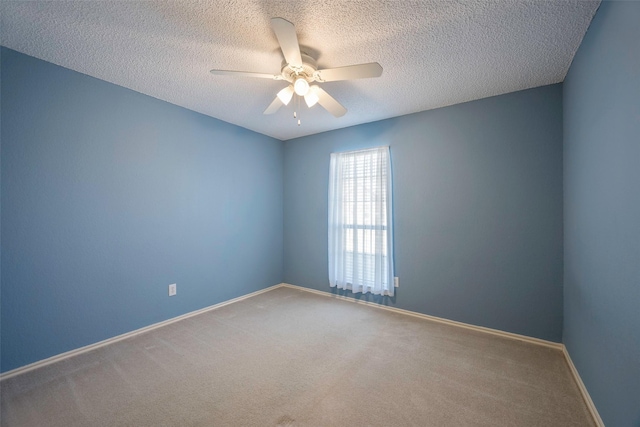 unfurnished room featuring carpet, ceiling fan, and a textured ceiling