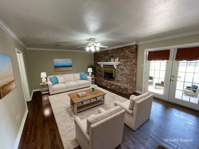 living room featuring a textured ceiling, a fireplace, and dark wood-type flooring