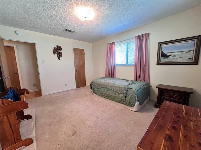 carpeted bedroom featuring a textured ceiling