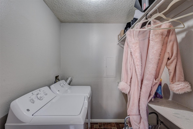 laundry area featuring washer and clothes dryer and a textured ceiling