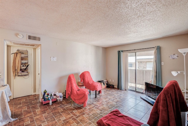 living area with a textured ceiling