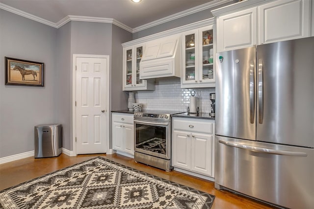 kitchen featuring dark hardwood / wood-style flooring, ornamental molding, custom exhaust hood, stainless steel appliances, and white cabinets