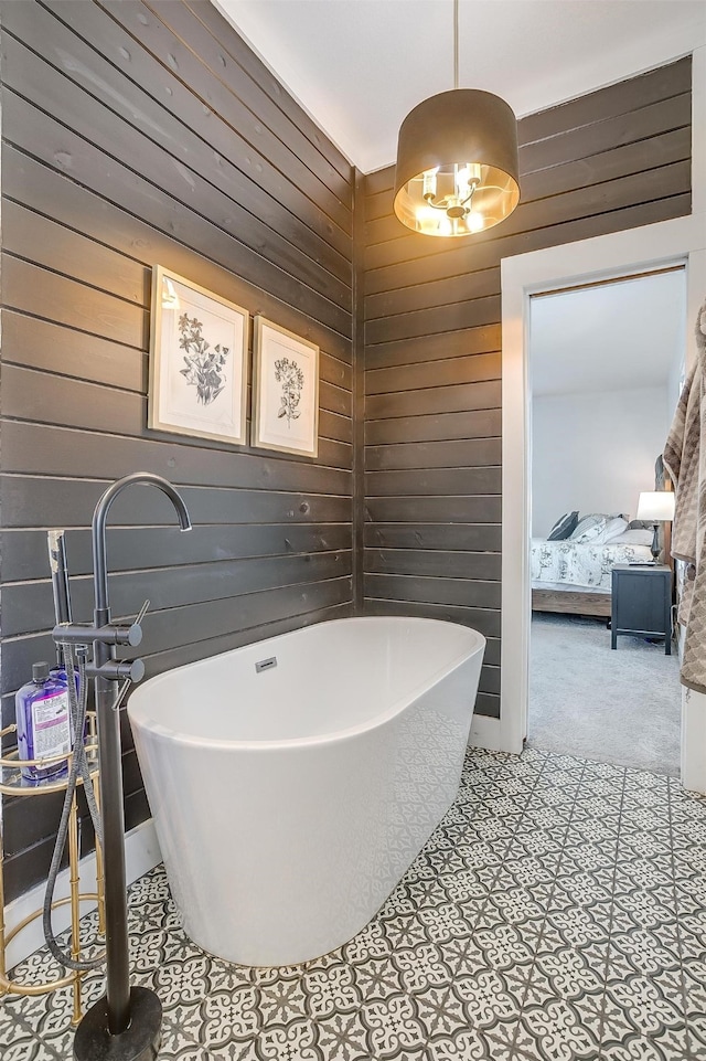 bathroom featuring a tub and wooden walls