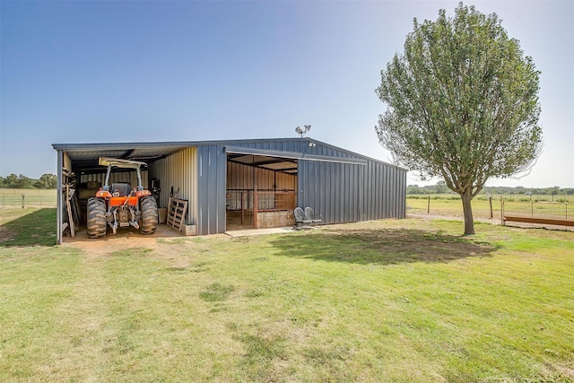 view of yard with an outbuilding and a rural view