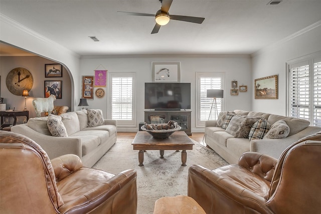 living room with ceiling fan, light hardwood / wood-style floors, and ornamental molding