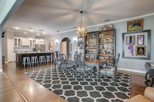 dining space featuring a chandelier, crown molding, and dark wood-type flooring