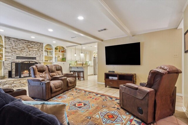 living room featuring a fireplace, beamed ceiling, light tile patterned floors, and ornamental molding