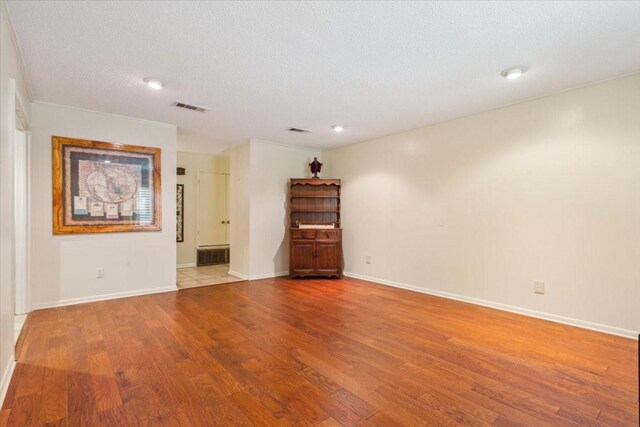 tiled spare room with a textured ceiling