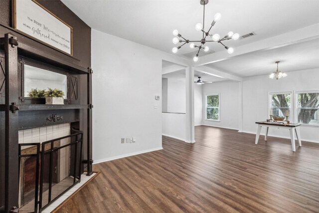 living room featuring beamed ceiling, ceiling fan with notable chandelier, dark hardwood / wood-style flooring, and a healthy amount of sunlight