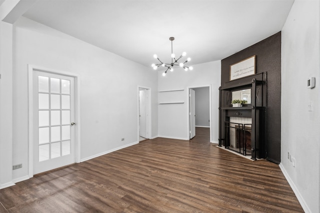 unfurnished dining area featuring dark hardwood / wood-style floors and an inviting chandelier