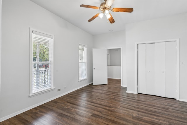 unfurnished bedroom featuring a closet, dark hardwood / wood-style flooring, and ceiling fan