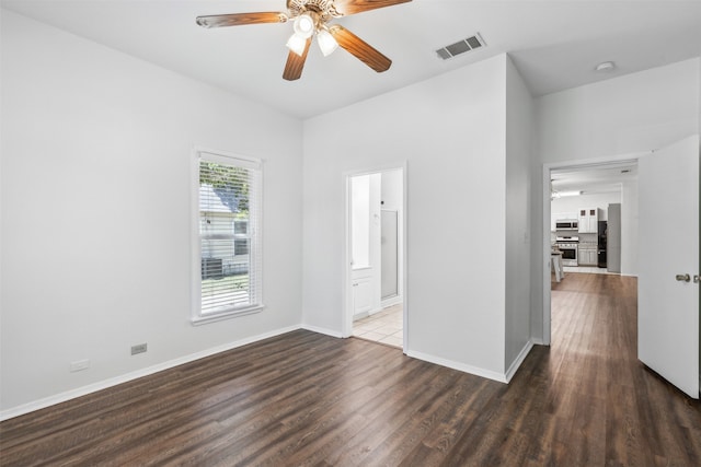 spare room with ceiling fan and tile patterned floors