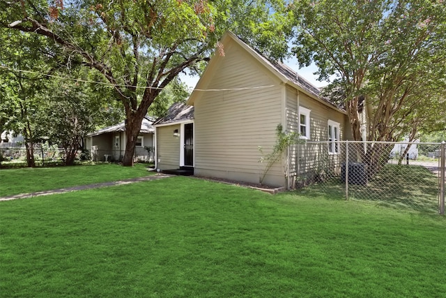 rear view of house with a lawn